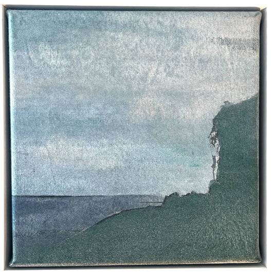 An original mixed media painting on canvas of a beach scene and water  with a light blue sky in a white wood frame by Annette Sullivan Art